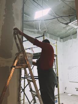 Certified inspector examining parapet wall structure